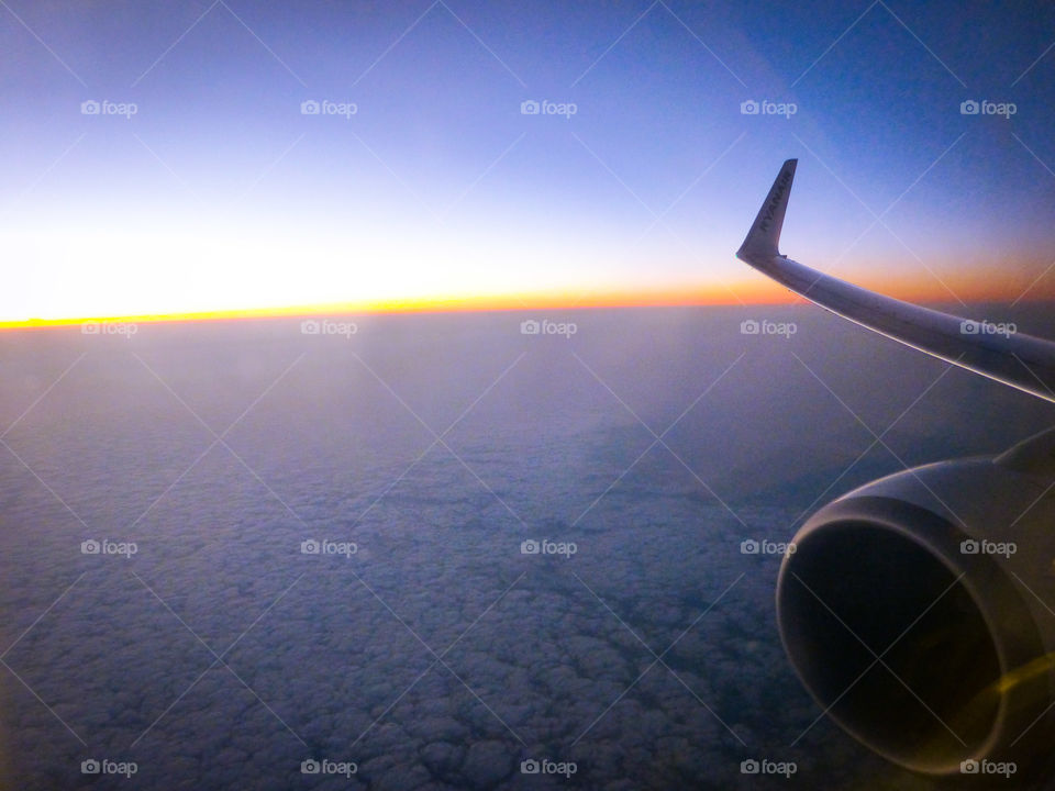 Close-up of airplane flying during sunset