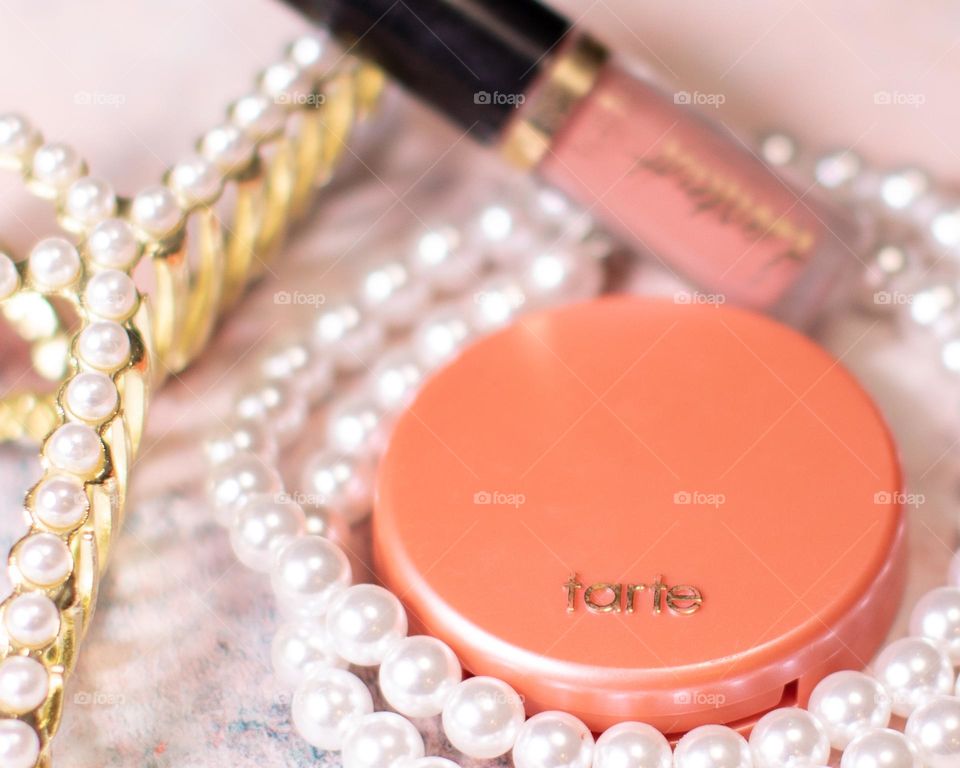 Pretty in pearls; flatlay with blush and liquid lip color