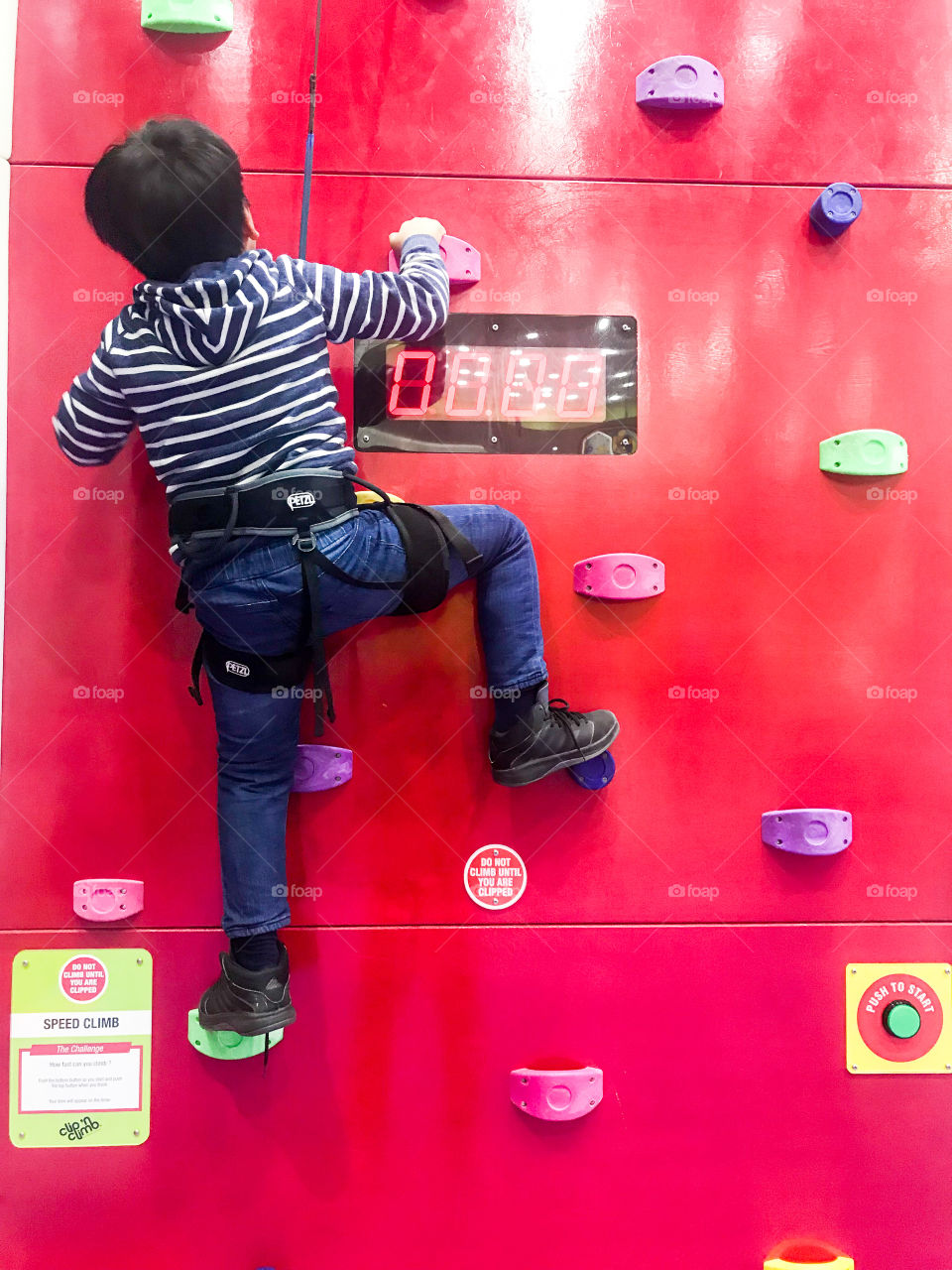 Kid climbing wall holds
