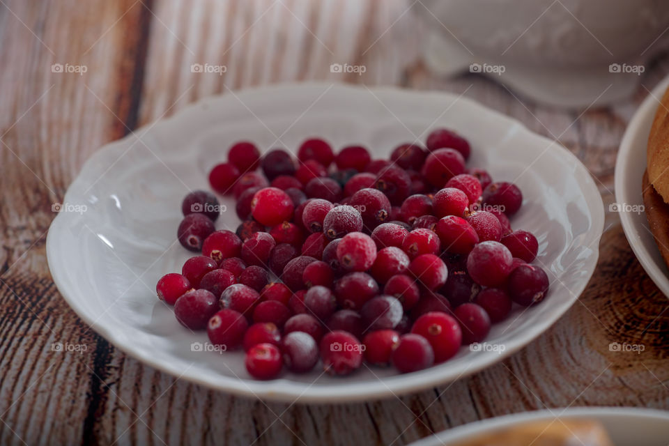 frozen cranberries on white ceramic plate 