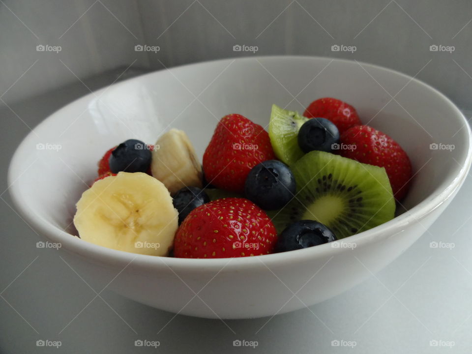 Healthy fruits breakfast full of vitamins with strawberry, kiwi, banana and berries