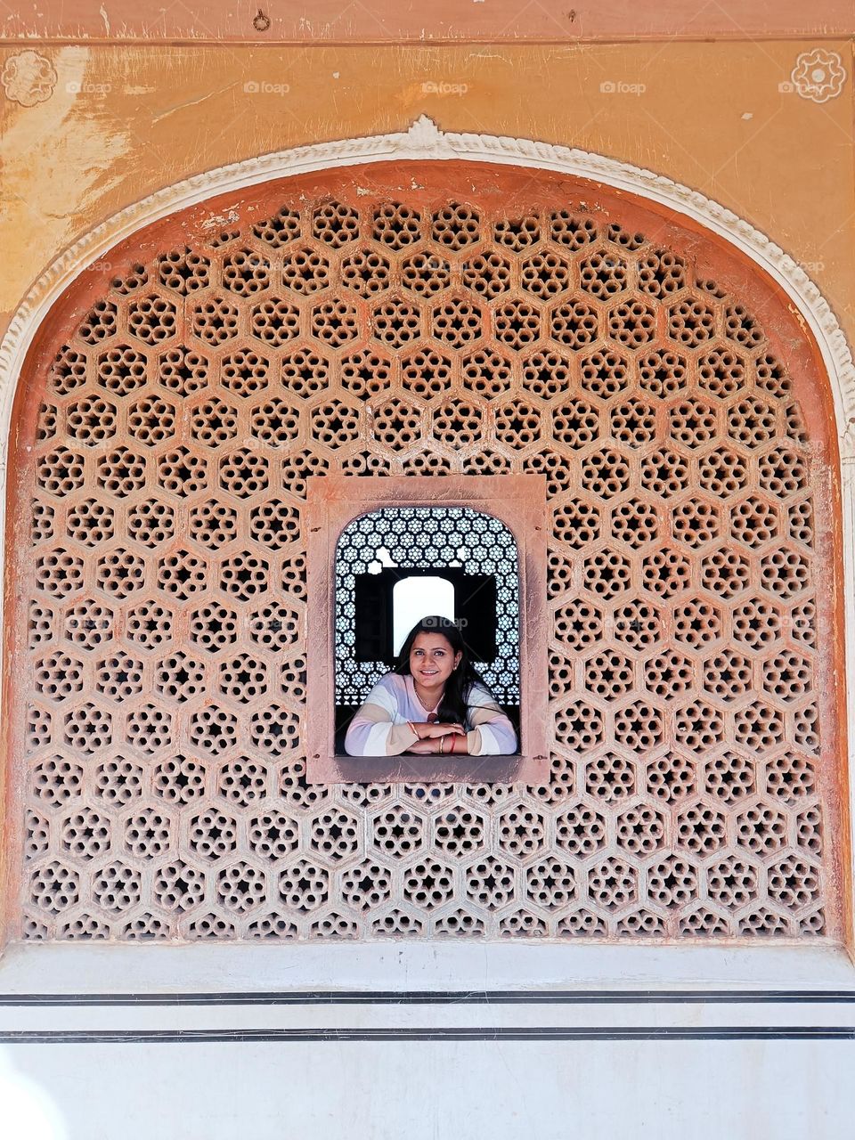 I took this photo of my wife while we were on a trip to Jaipur. I remember we were completely exhausted at that time by all the walking yet she managed to pose for me when I insisted on getting a photo clicked.