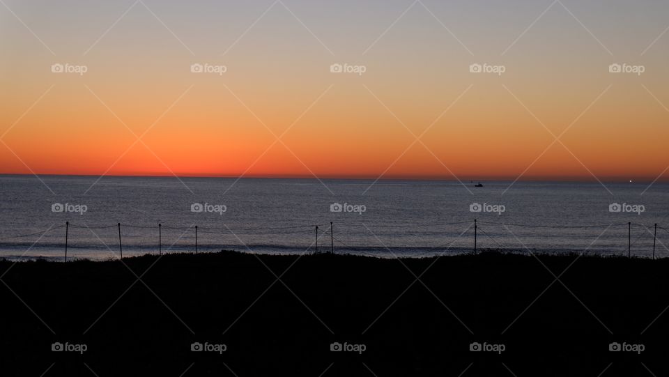 Red, orange and yellow sunset on the coast