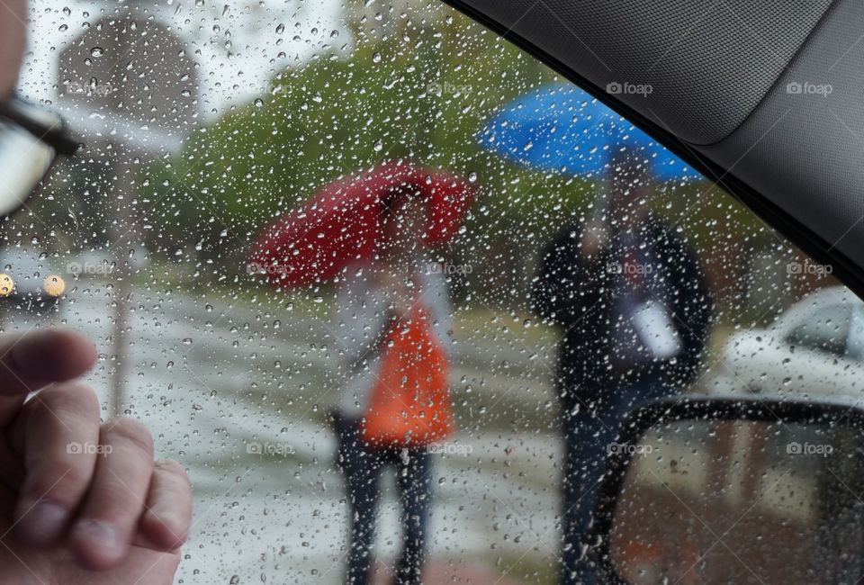 Walking in the rain. Photo taken from car