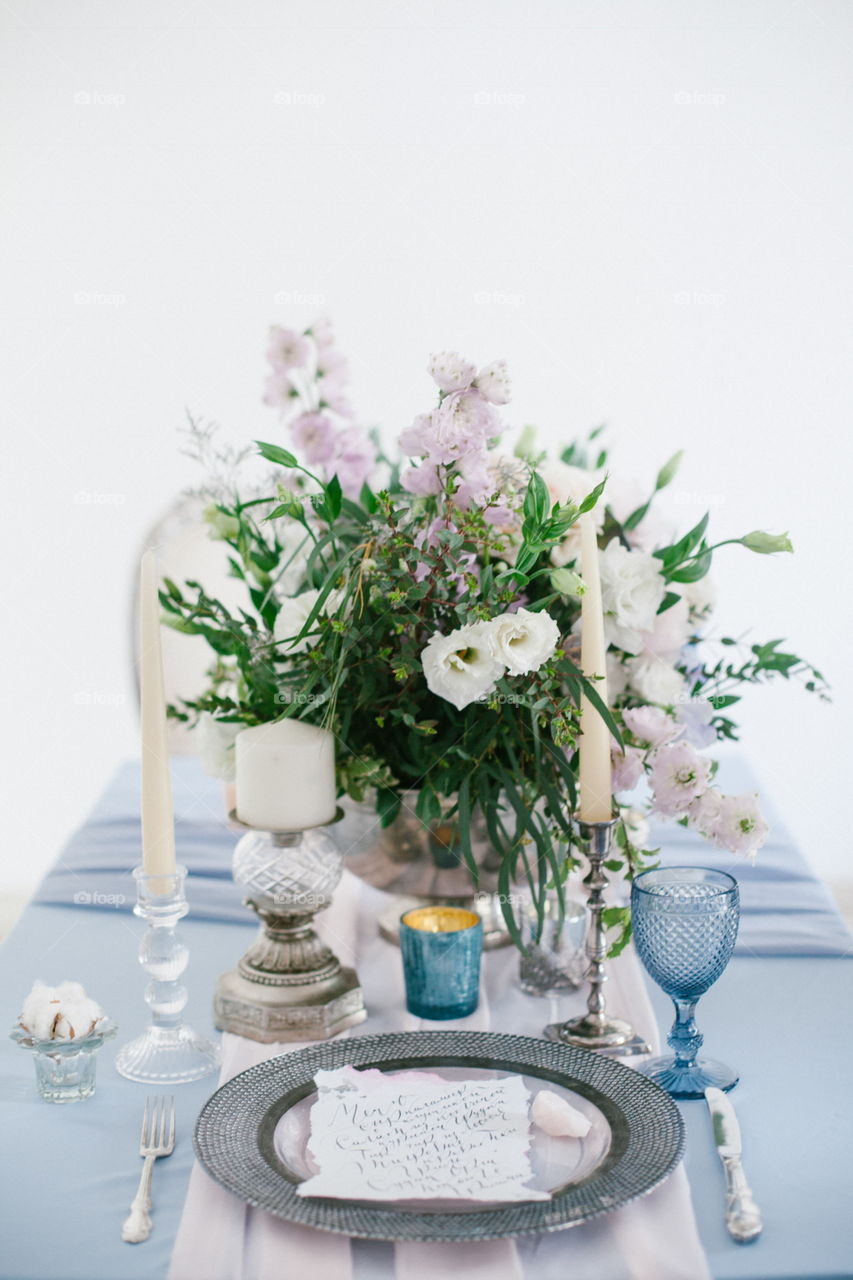 Silver candlestick and other elements of festive table wedding centerpieces decorations.