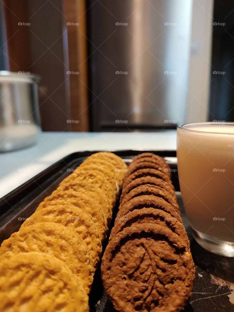 cookies on a tray with a mug of milk