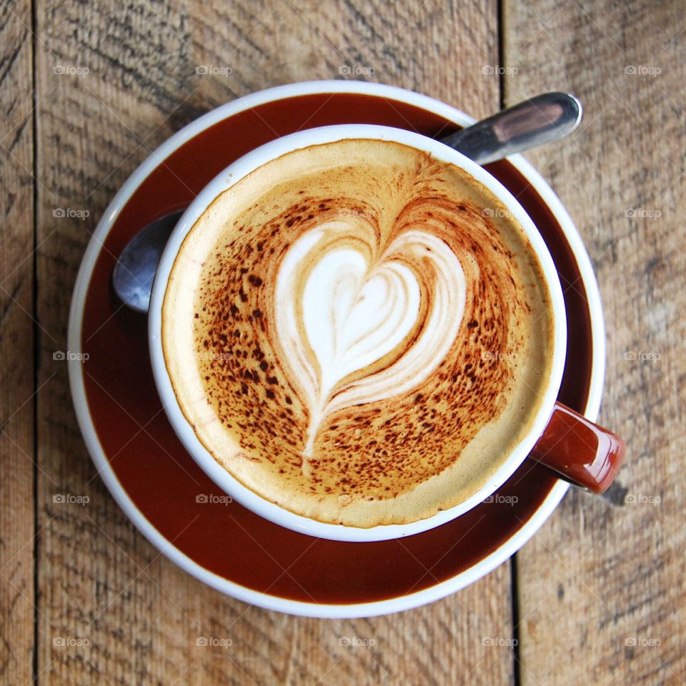 Coffee Heart. A barista made a heart shaped pattern in a hot cup of coffee.