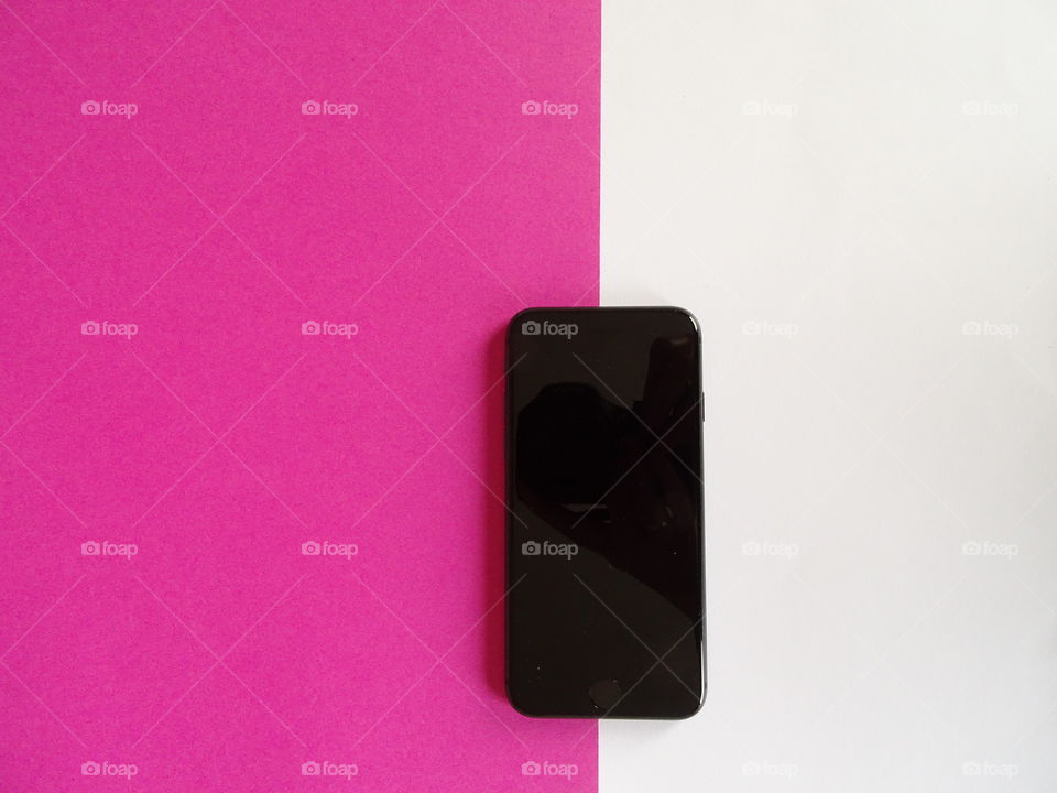 Phone on pink and white background 