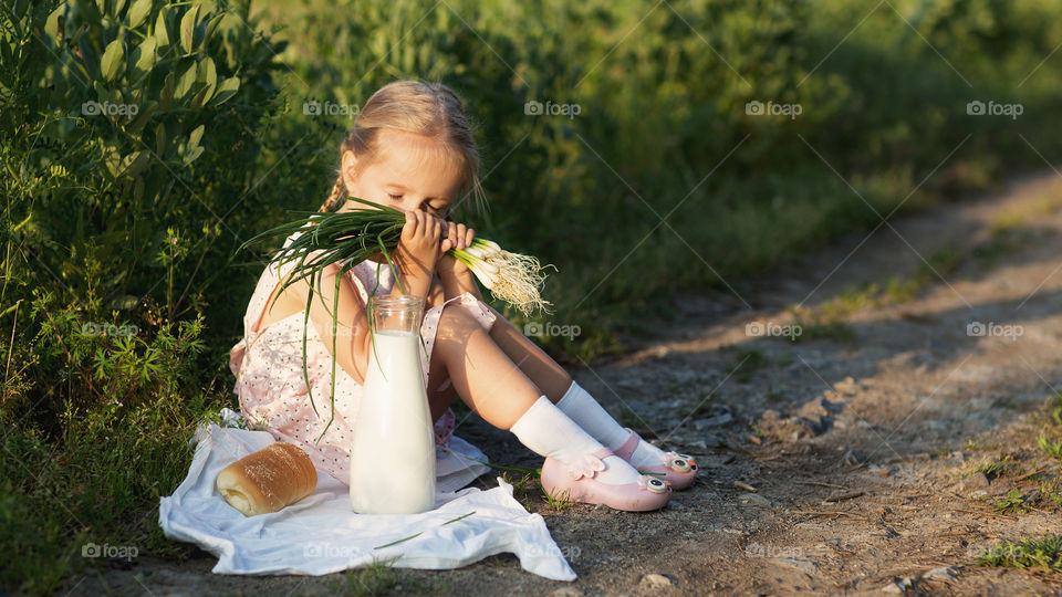 Little girl with blonde hair in village 