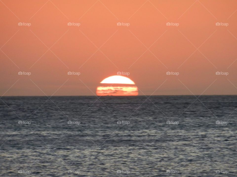 View of sun setting at the horizon