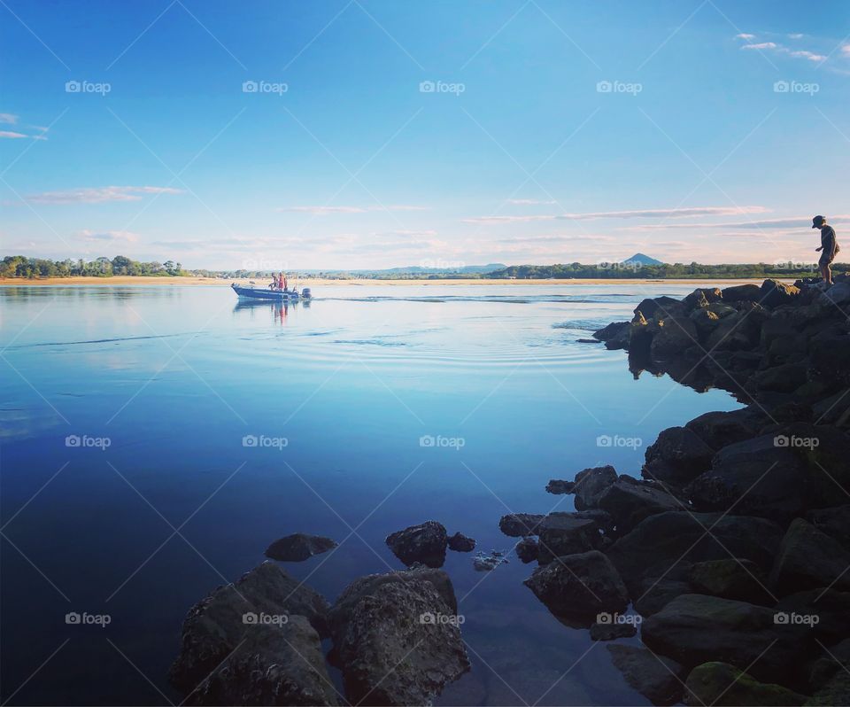 Reflections on blue water with a boat