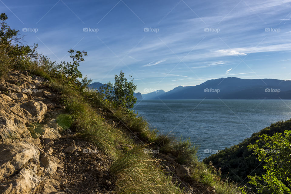 Walking on a path in the woods around the "Rocca di Manerba", lake Garda, Italy.