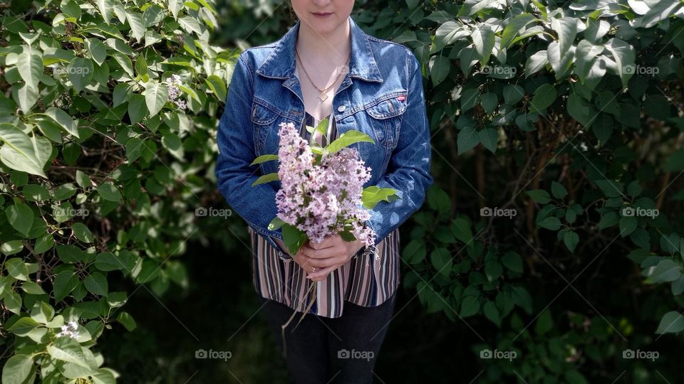 girl with a bouquet of lilacs in her hands