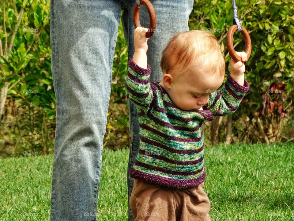 Learning To Walk. Toddler Girl Learning To Walk With Help From Mom
