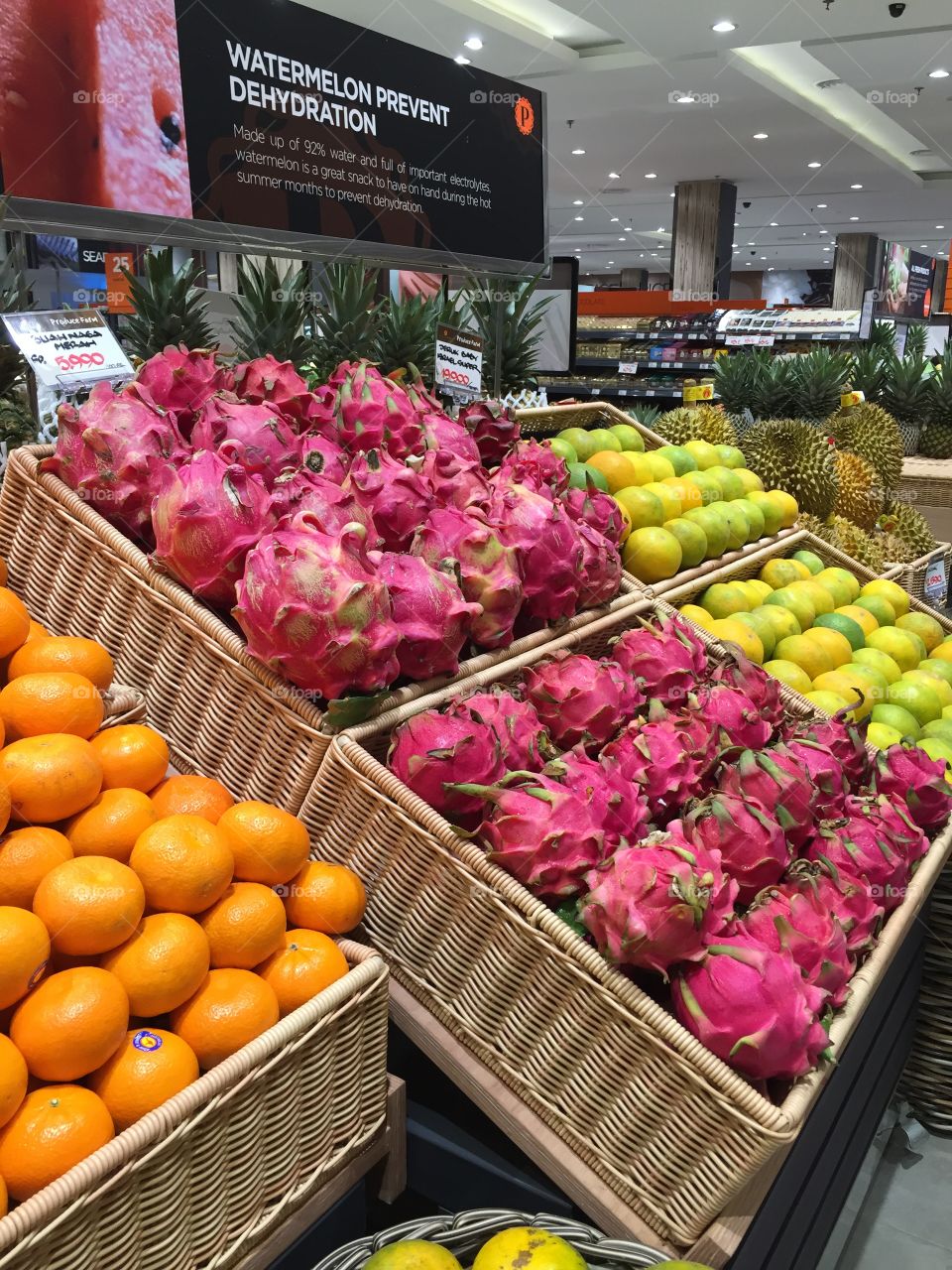 various kinds of fruit on display such as oranges, dragon fruit etc.