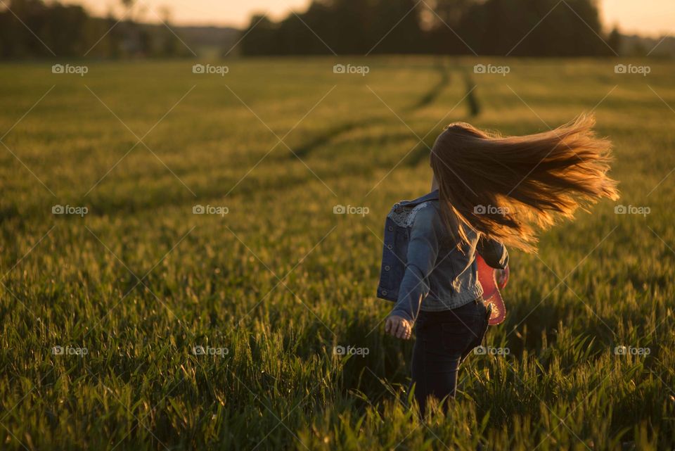 Rear view of girl with hair in the wind