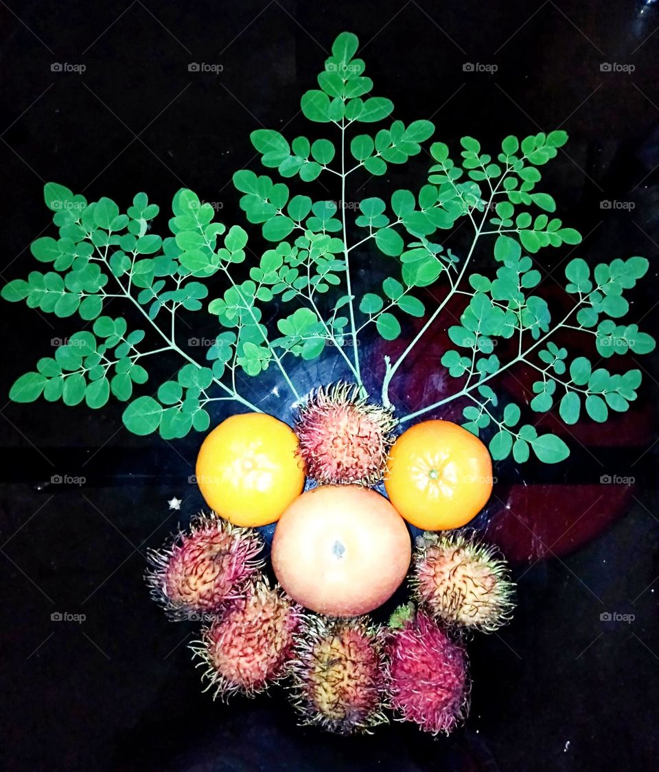 Eating apple, orange and rambutan a day keeps the doctor away with Moringa leaves to boost naturally the immune system.