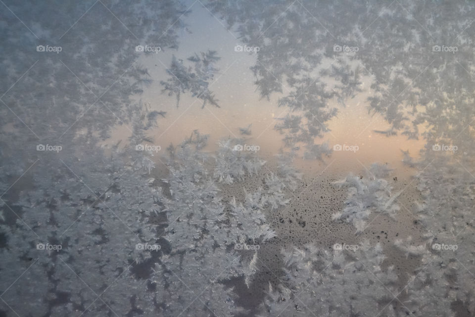 Snow crystals on window early winter morning 