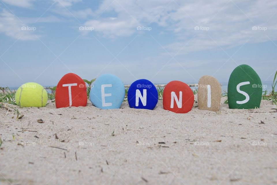 Tennis concept on colourful stones