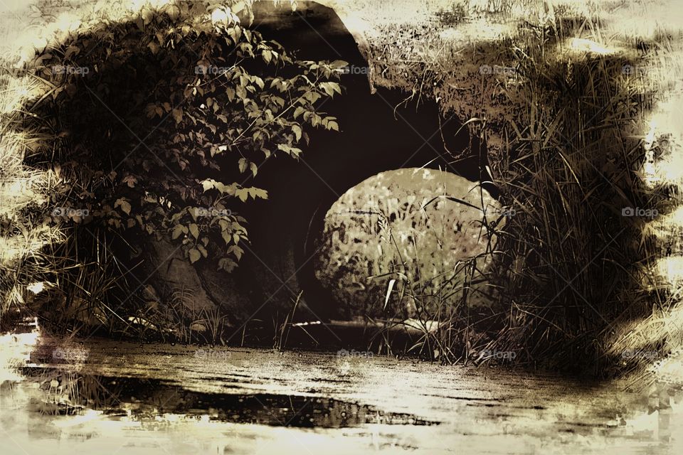 Sepia, metal tunnel with standing water 