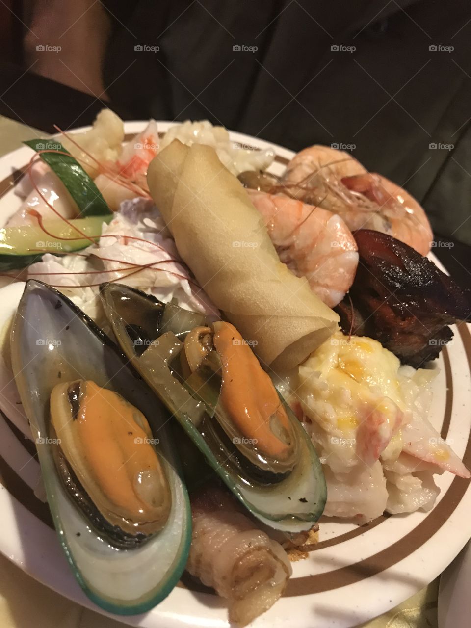 A yummy plate of seafood and Chinese food.
