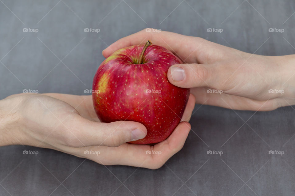 Woman's hand holding red apple