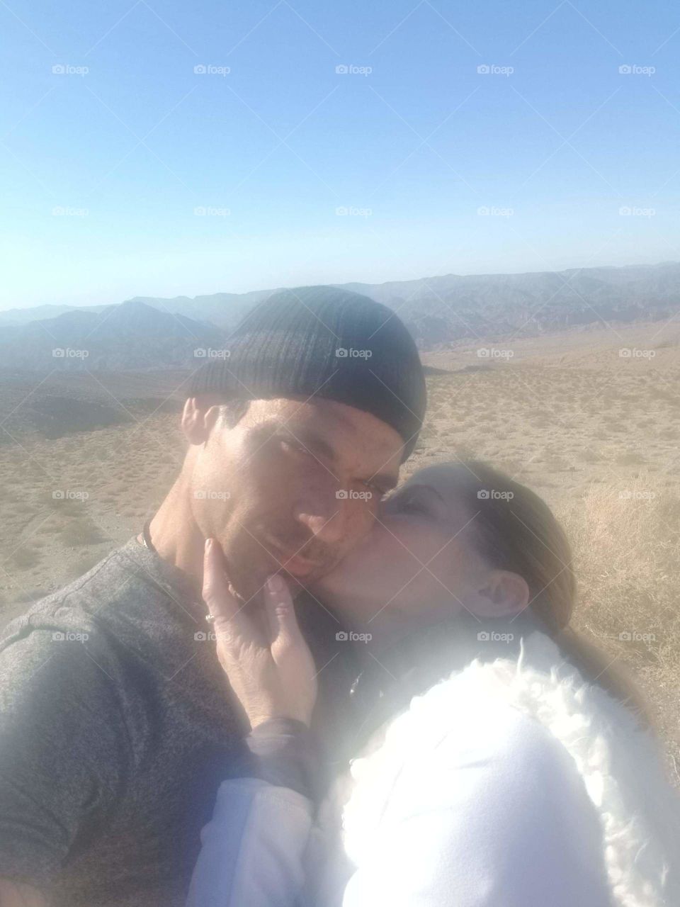 sweaty from the 45:,,min lo motorcycle ride to the desert look out; my love and I, we took a selfie and I stole a kiss, fogging up the camera lense