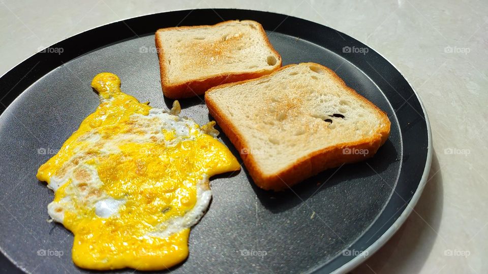 Egg omelette with bread toast in a pan, home made simple breakfast, healthy egg recipes, egg dishes