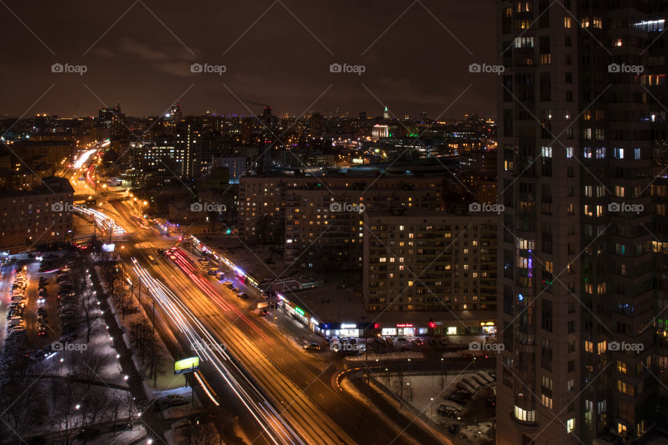 Lights of the night city of Moscow.  Headlights of fast passing cars.