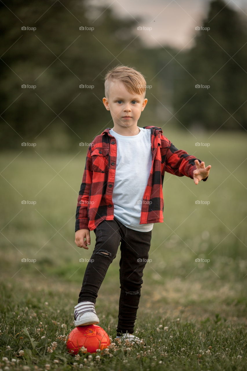 Little boy playing in soccer in a park 