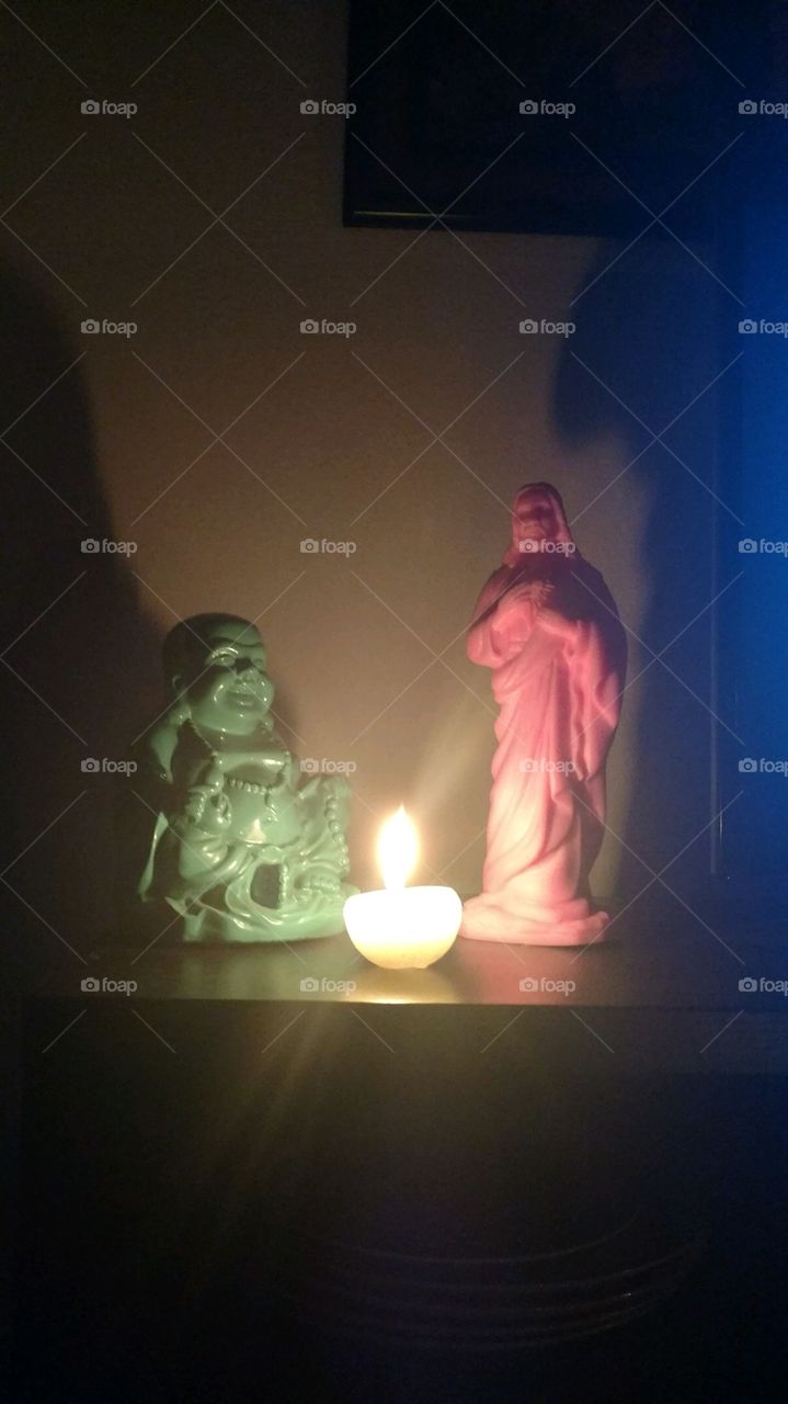 jesus and buddha with candle