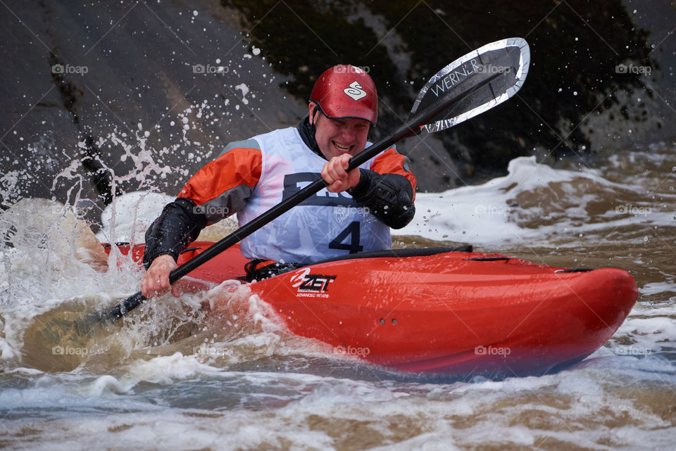 Helsinki, Finland -  April 15, 2018: Unidentified racer at the annual Icebreak 2018 whitewater kayaking competition at the Vanhankaupunginkoski rapids in Helsinki, Finland.