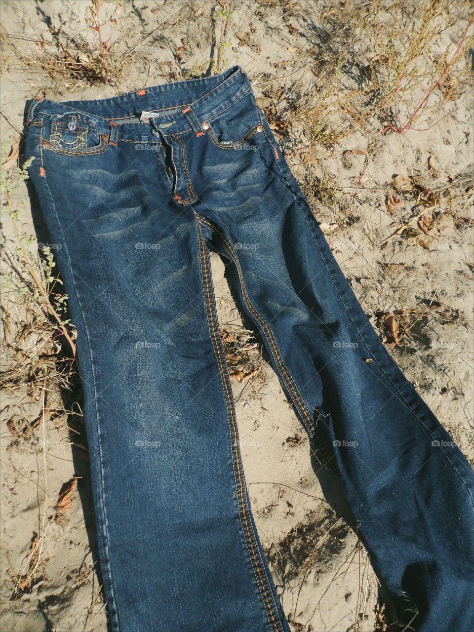 Jeans lie on the sand