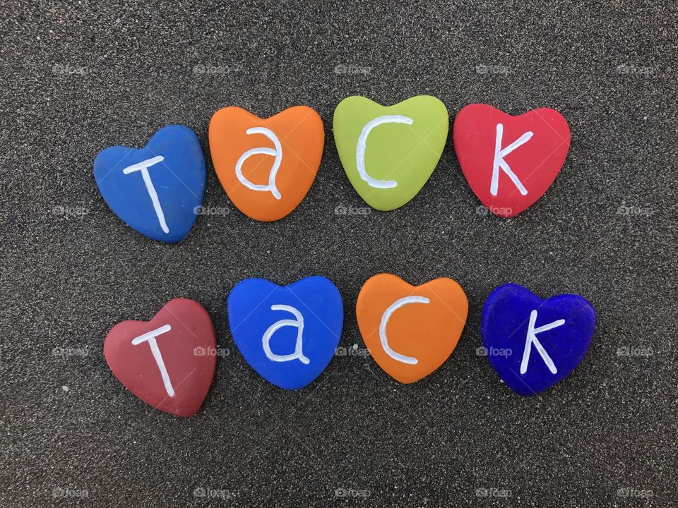 Tack, tack, double thank you with colored heart stones over black volcanic sand