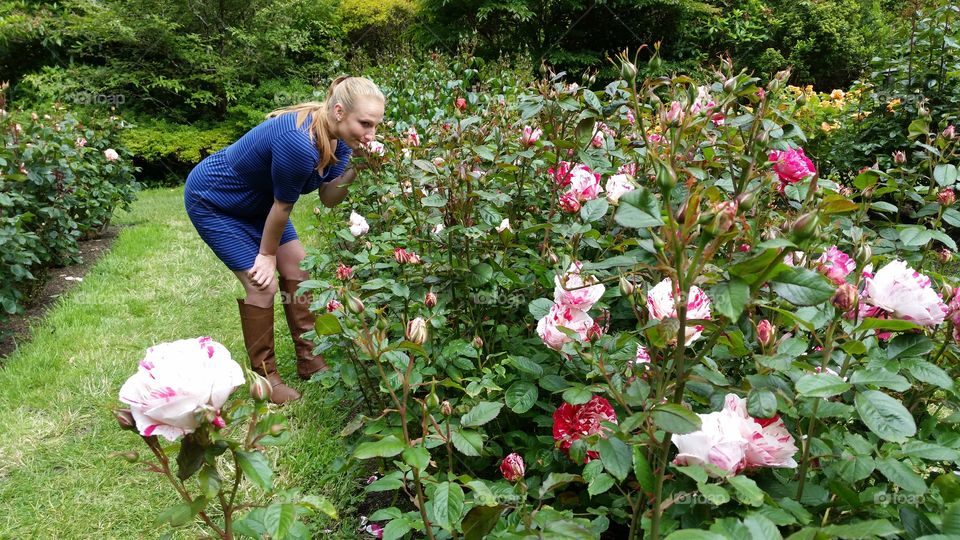 Woman smelling rose in garden