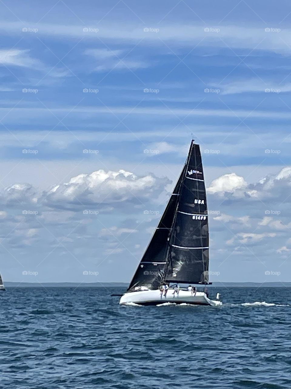 Black sails sailing under blue sky