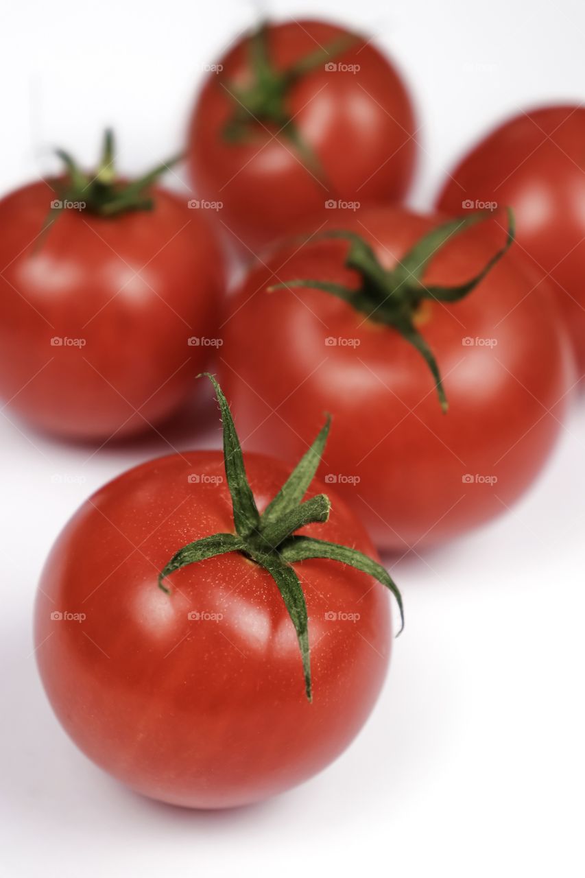 Red tomatoes on white background 