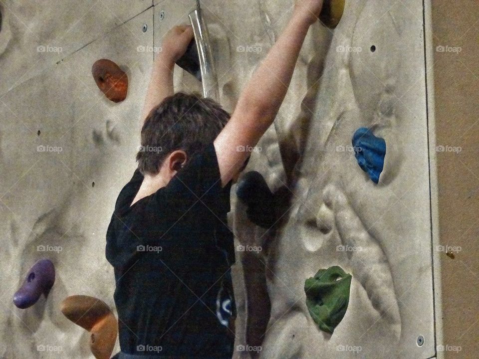 Boy Climbing Rock Wall