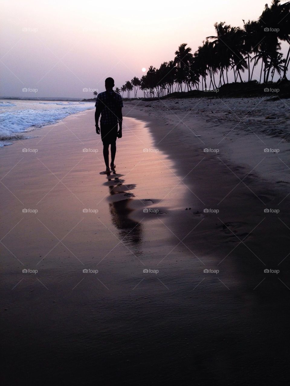 Man on the beach at sunset