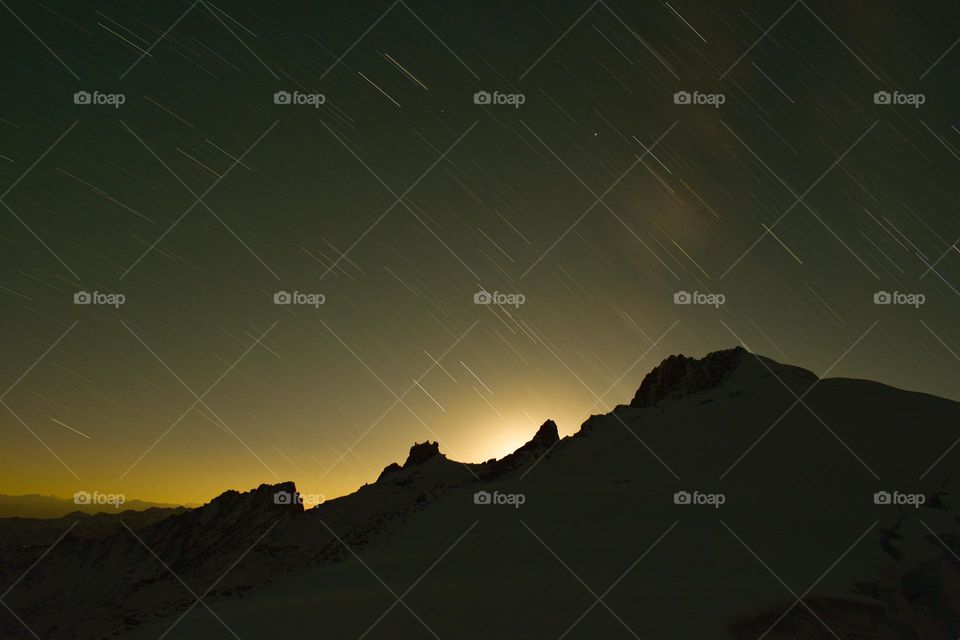 silhouette of mountain landscape and star trails