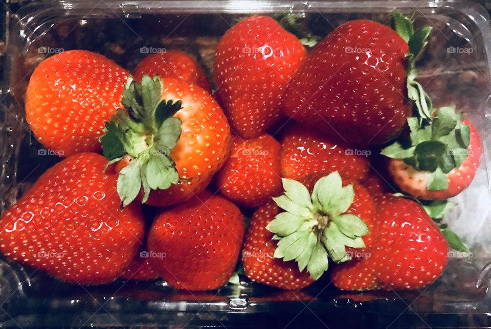 Bowl of Strawberries, red juicy and delicious sitting on the kitchen counter top. 