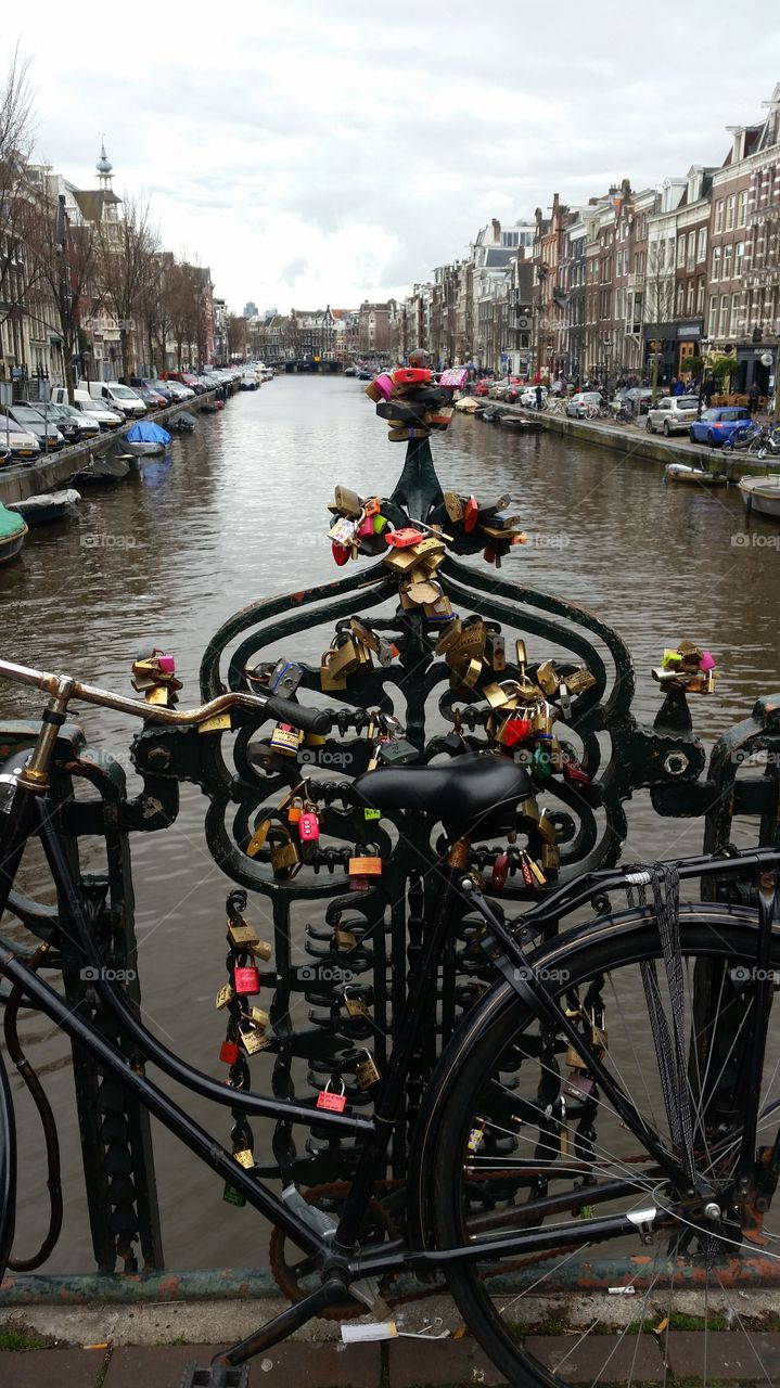 Love locks. This picture was taken in Amsterdamn on a cold day in March. It is a picture of love locks overlooking the river.