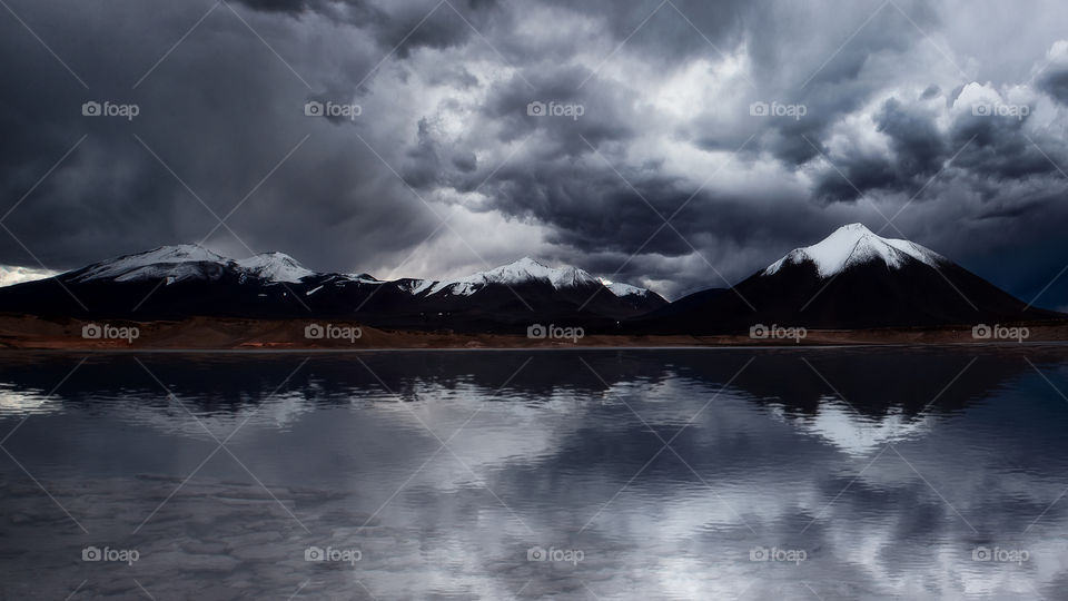 Mountain reflection in the green lagoon, Andes mountain range