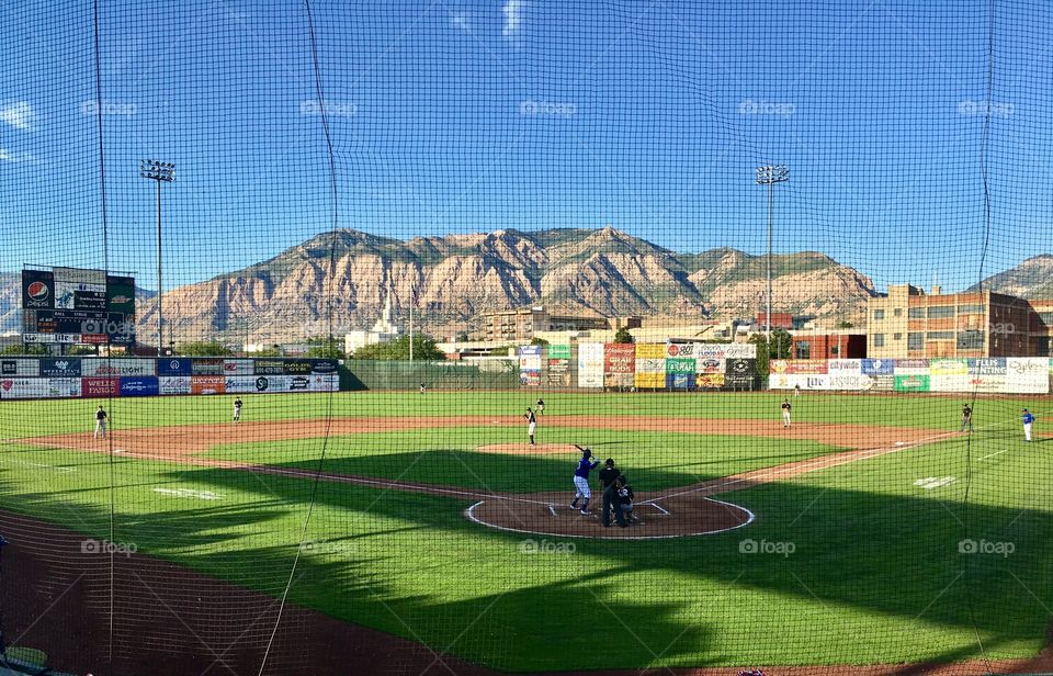 Perfect summer night. Endless summer.  Baseball. Sport. Mountains. Views. Latter-day Saint temple. Mormon. Blue skies. Perfect evening. Competition. Stadium.