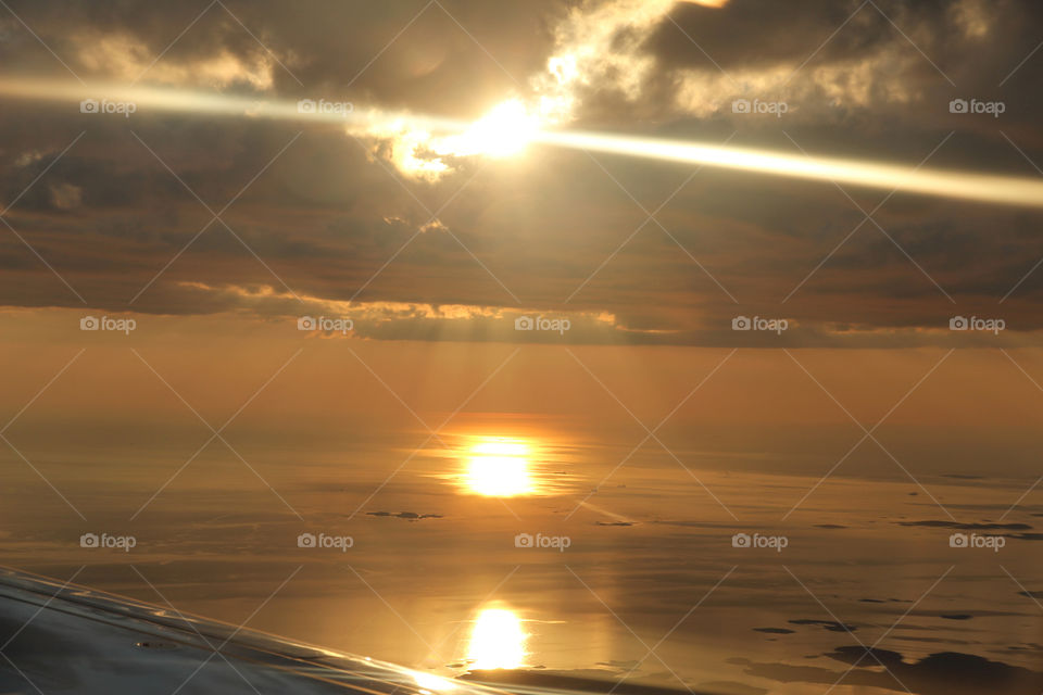 Sunrays over the ocean - view from airplane