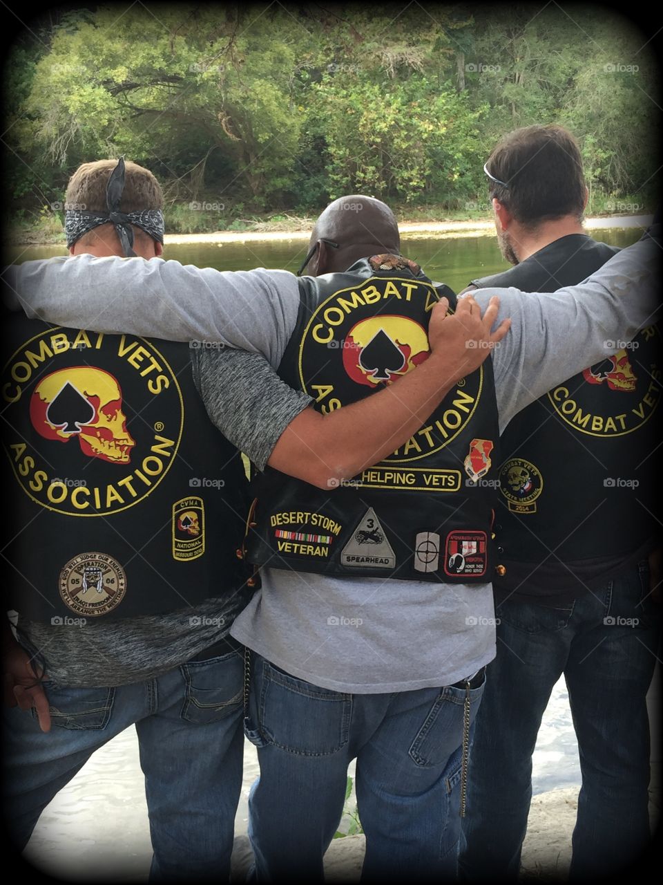 Brothers . three members of the chapter 23–9 combat veterans motorcycle group having a hug