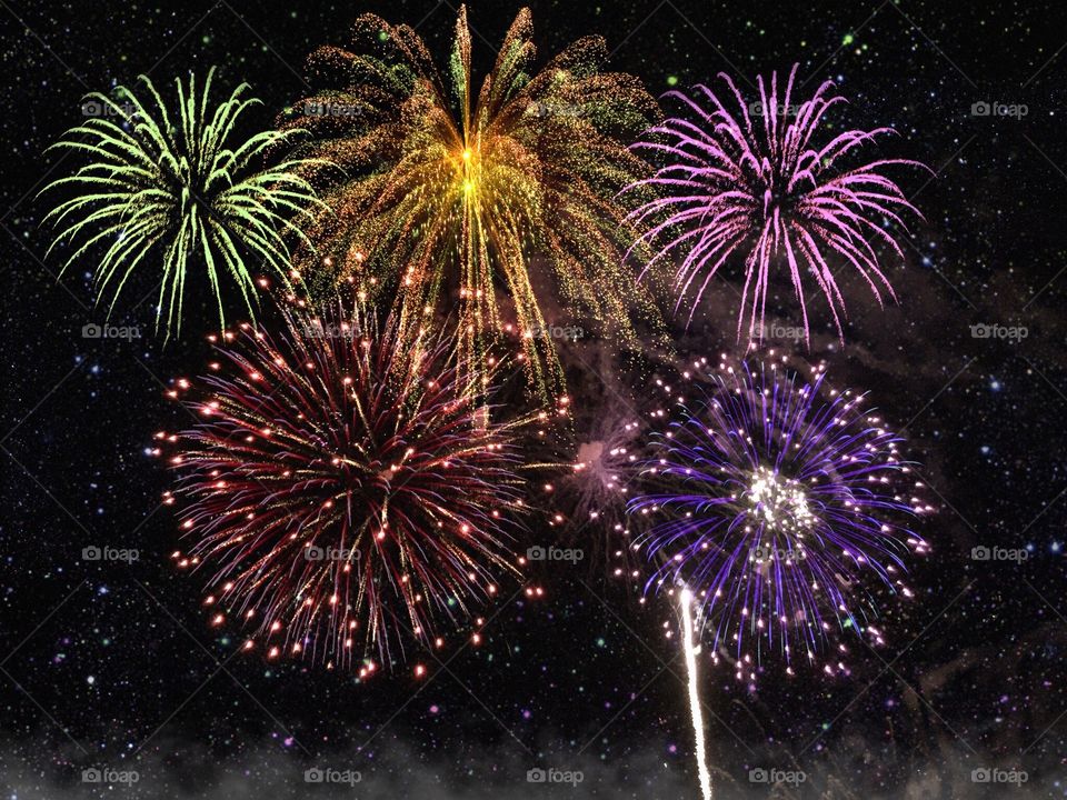 Dazzling multicolored fireworks light up the night sky.