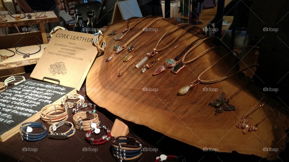 a crafts display at a homemade market with jewelry made of cork leather, beads, and precious stones