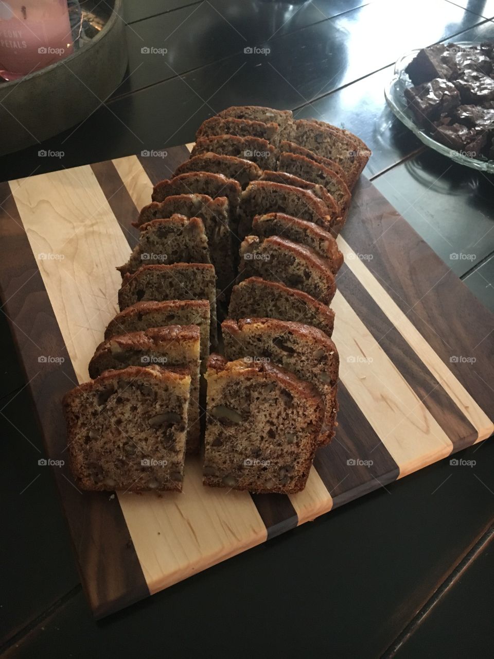 Delicious homemade banana bread sitting atop a homemade wood cutting board.