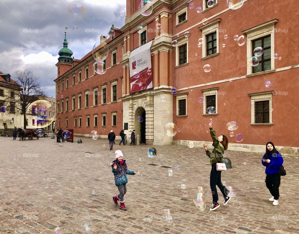 Old square in Warsaw and playing children 